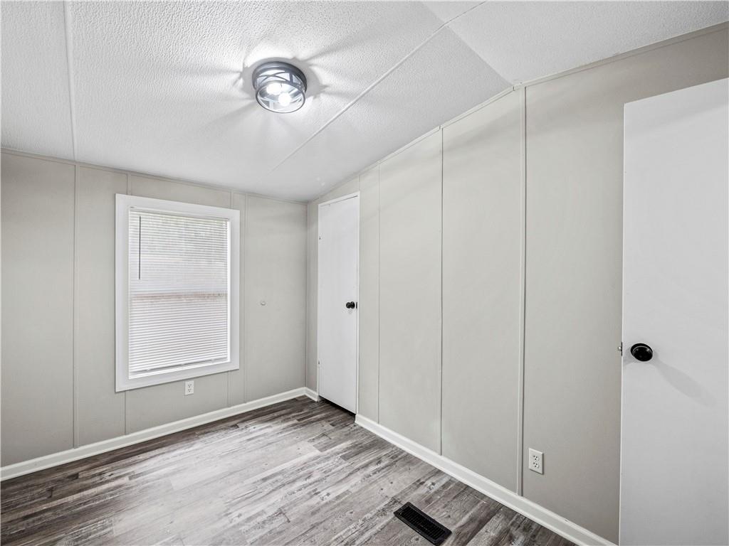 1458 Grant Mill Road Alto, GA 30510 - Photo 10 of 32 a view of an empty room with window and wooden floor