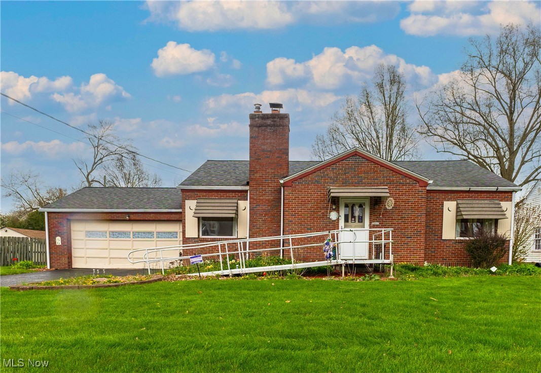 3631 Dover Road Youngstown, OH 44511 - Photo 1 of 20 View of front of property with fence, an attached garage, a front lawn, and driveway