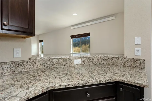 a view of a kitchen that has a sink and cabinets