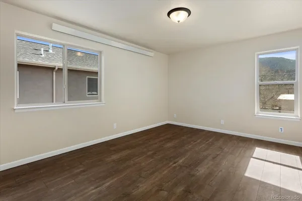 a view of an empty room and wooden floor