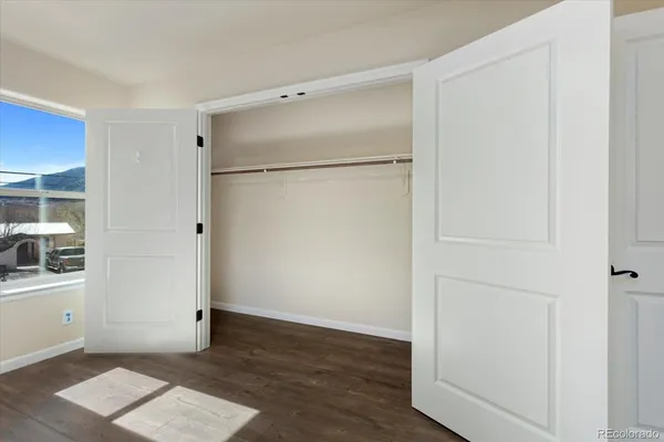 a bathroom with a granite countertop sink a toilet and shower