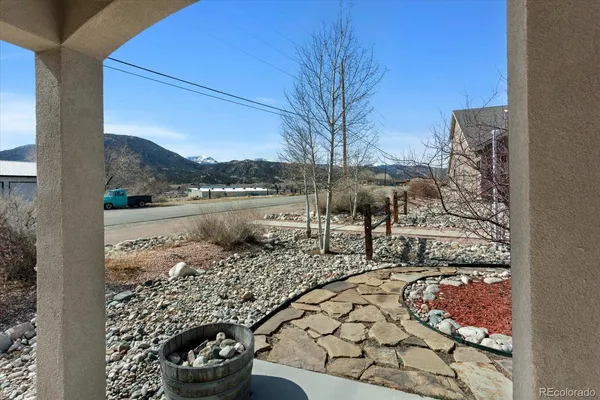 an aerial view of a house with a mountain