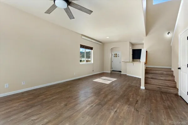 wooden floor in an empty room with a window