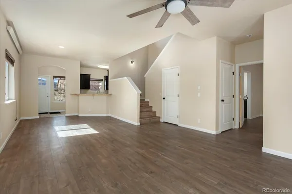 a view of empty room with wooden floor