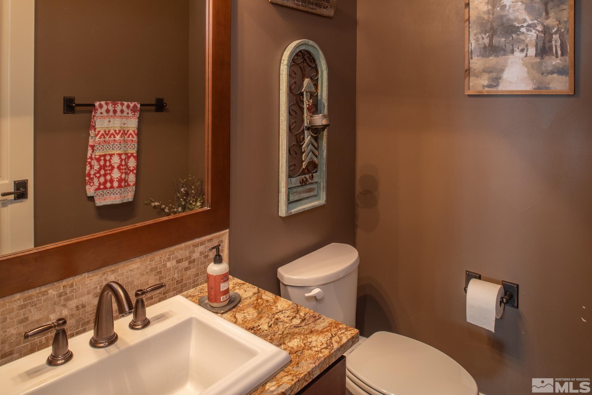 3910 Nature Trail Reno, NV 89511 - Photo 19 of 29 a bathroom with a toilet sink and mirror