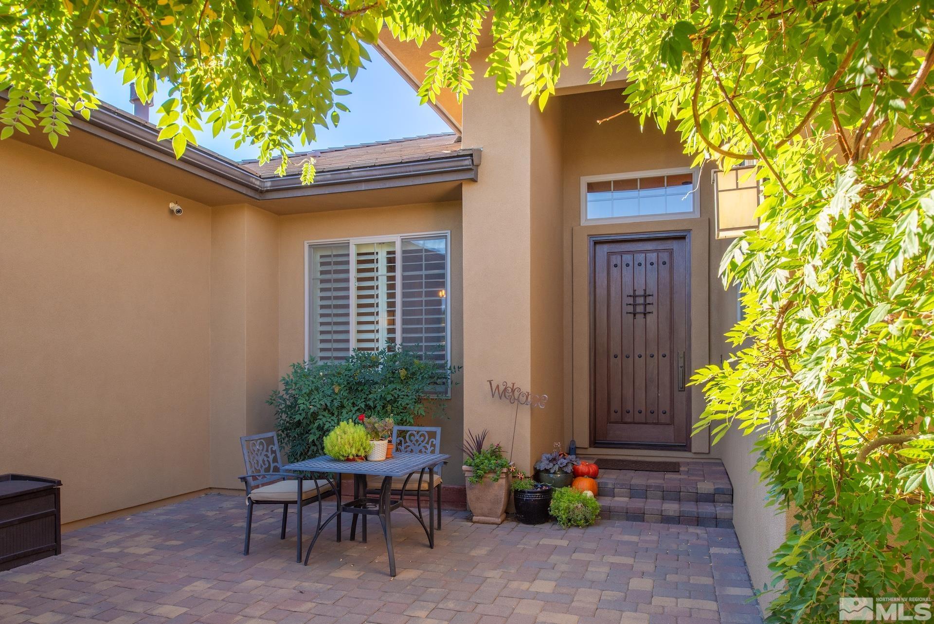 3910 Nature Trail Reno, NV 89511 - Photo 4 of 29 a view of patio with a table and chairs and potted plants