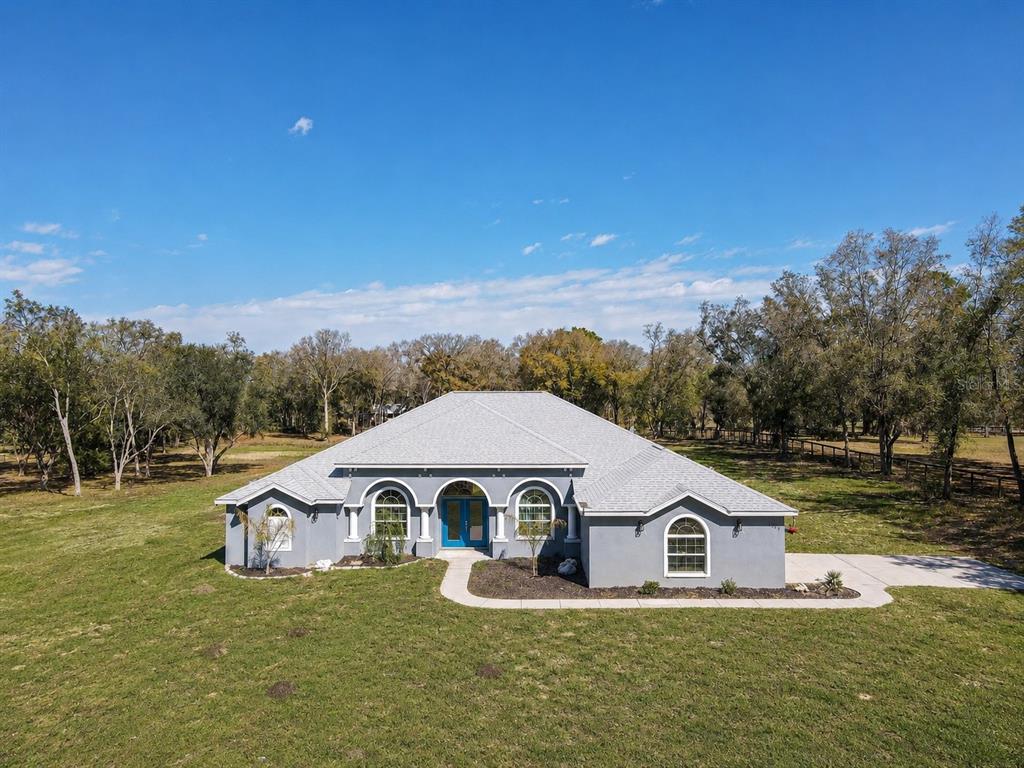 10688 Southwest 129th Terrace Road Dunnellon, FL 34432 - Photo 2 of 35 a view of a house with a yard