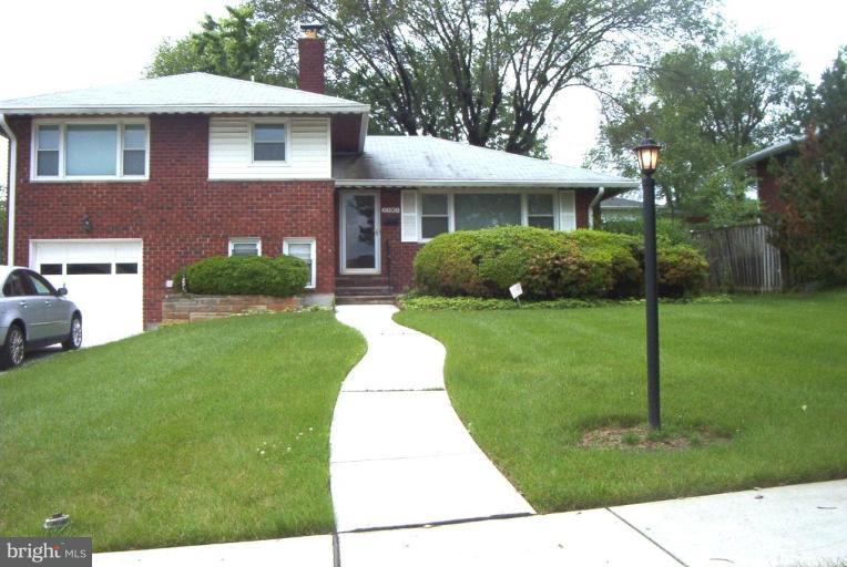 6608 Edenvale Road Baltimore, MD 21209 - Photo 1 of 30 a front view of a house with a yard and potted plants