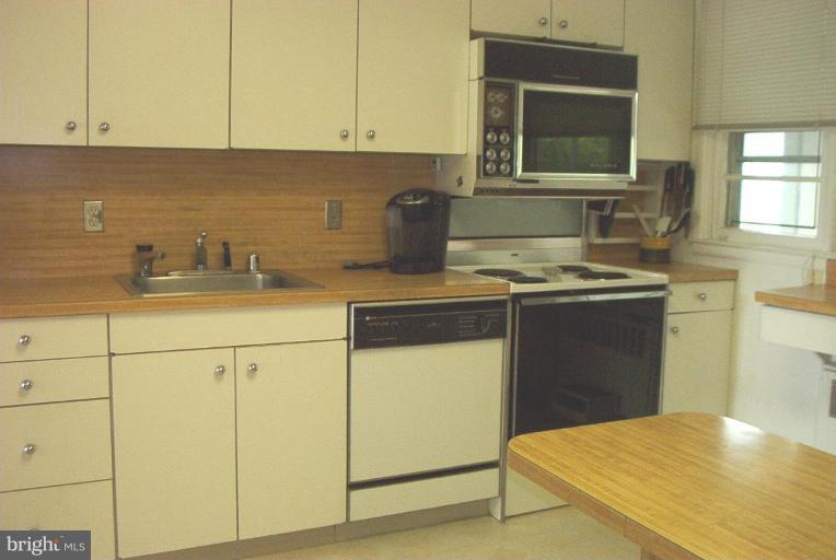 6608 Edenvale Road Baltimore, MD 21209 - Photo 11 of 30 a kitchen with sink cabinets and appliances