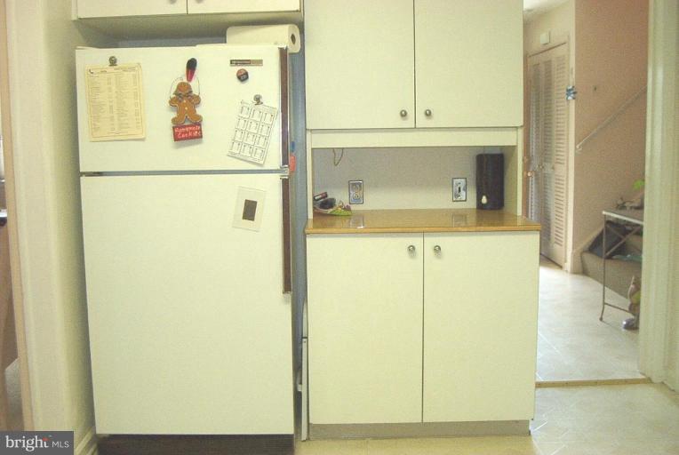 6608 Edenvale Road Baltimore, MD 21209 - Photo 12 of 30 a white refrigerator freezer sitting inside of a kitchen