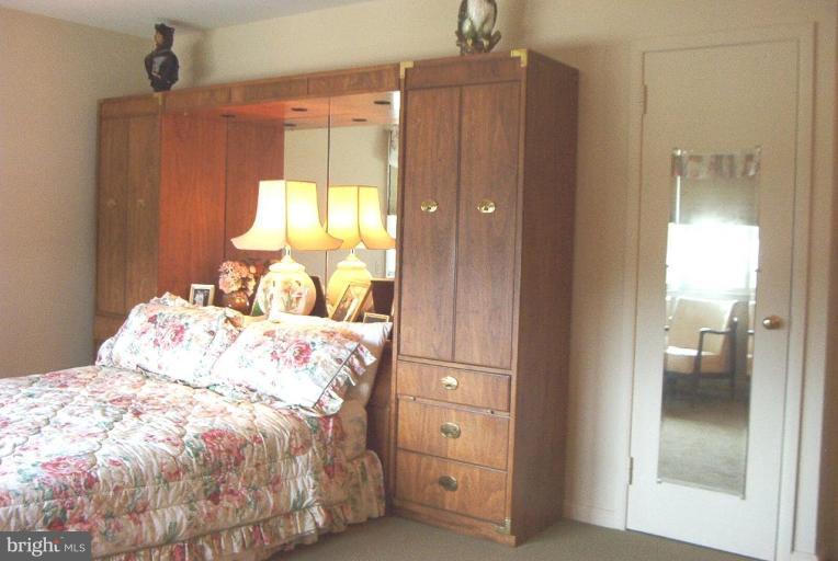 6608 Edenvale Road Baltimore, MD 21209 - Photo 13 of 30 a bedroom with a bed and a mirror