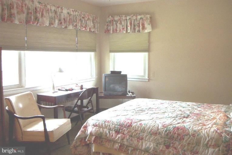 6608 Edenvale Road Baltimore, MD 21209 - Photo 14 of 30 a bedroom with a bed and wooden floor