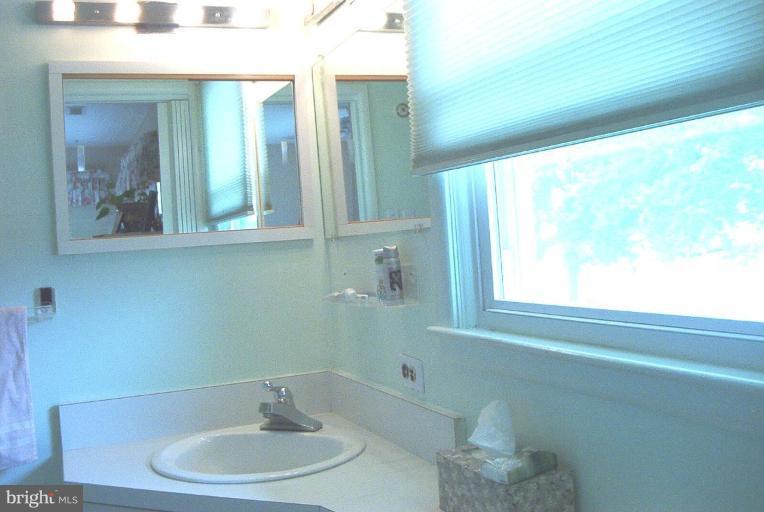 6608 Edenvale Road Baltimore, MD 21209 - Photo 16 of 30 a bathroom with a sink and a mirror