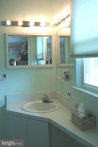 6608 Edenvale Road Baltimore, MD 21209 - Photo 17 of 30 a bathroom with a sink and a mirror