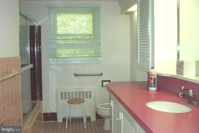 6608 Edenvale Road Baltimore, MD 21209 - Photo 21 of 30 a bathroom with a sink a toilet and mirror