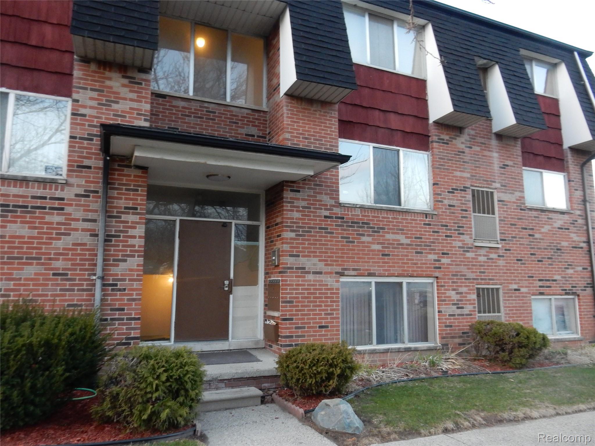 150 Arcola Street, Unit 3 Inkster, MI 48141 - Photo 1 of 15 Property entrance featuring mansard roof and brick siding