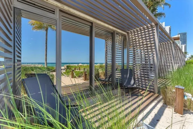 a living room with furniture and a floor to ceiling window