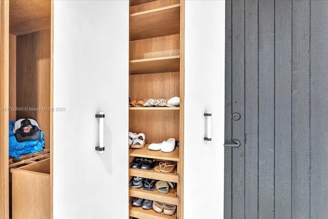 a spacious bedroom with a bed and wooden floor