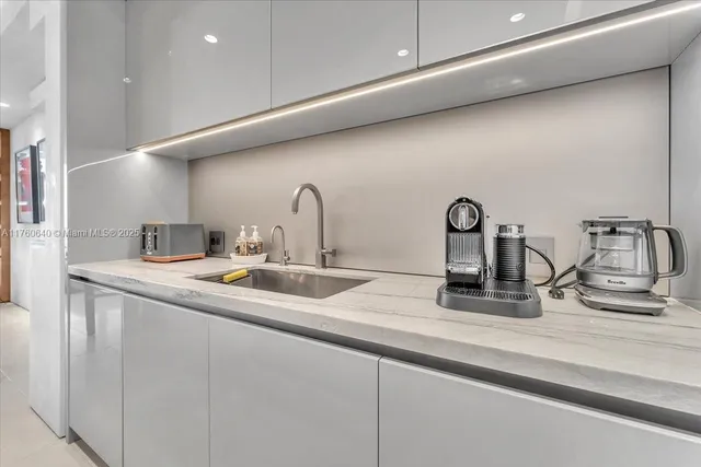 a bedroom with a bed and large windows