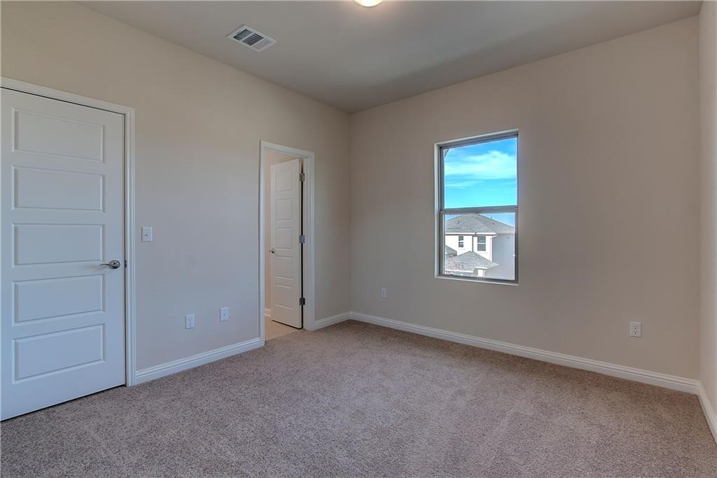 6907 Idea Road Austin, TX 78741 - Photo 16 of 29 2nd level bedroom with a full bath, and carpet