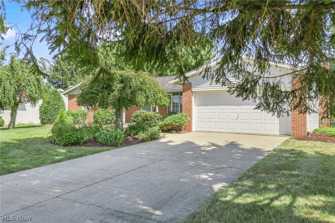 View of front facade with a garage and a front lawn