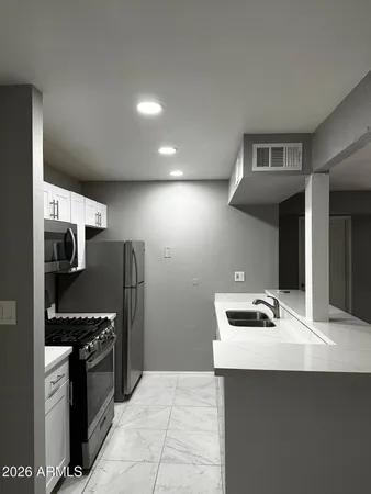 a kitchen with stainless steel appliances a sink and a stove top oven