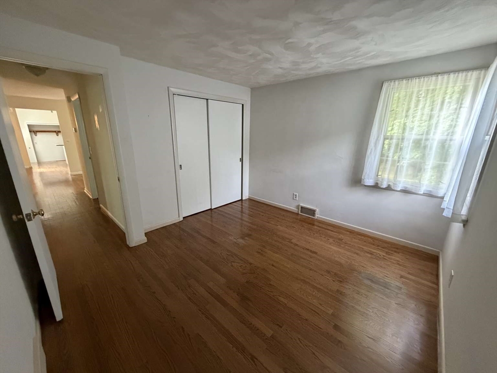 74 Birch Road Longmeadow, MA 01106 - Photo 16 of 38 wooden floor in an empty room with a window