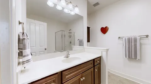 a bathroom with a glass shower door