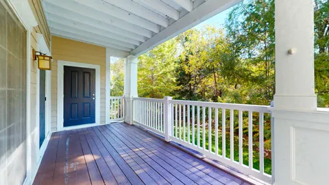 a view of empty room with wooden floor and floor to ceiling window