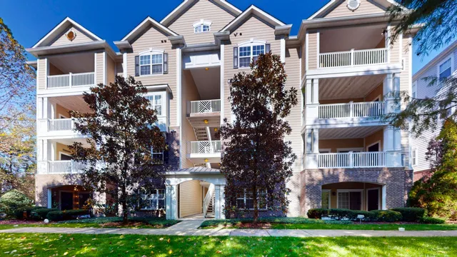 a front view of a house with a garden and plants