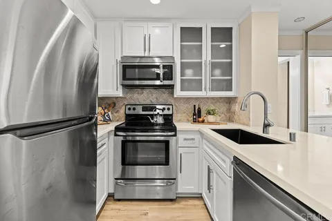 a kitchen with a refrigerator stove and sink