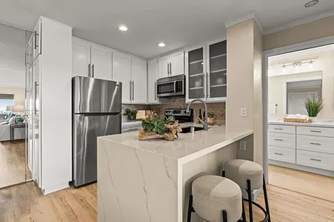 a kitchen with appliances cabinets and furniture