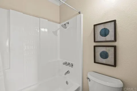 a bathroom with a toilet a bath tub and a shower