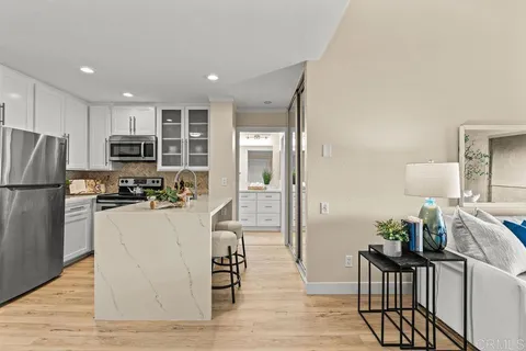 a kitchen with stainless steel appliances granite countertop a refrigerator and a stove top oven