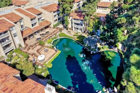 an aerial view of a house with a yard and garden