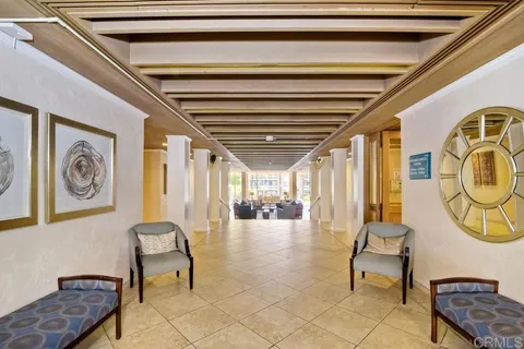 a living room with fireplace furniture and a large window