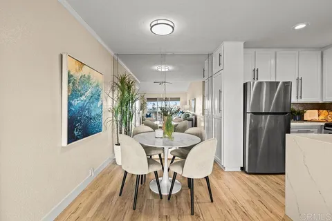 a dining room with furniture and a refrigerator