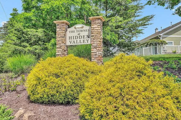 a sign broad in front of a blue park