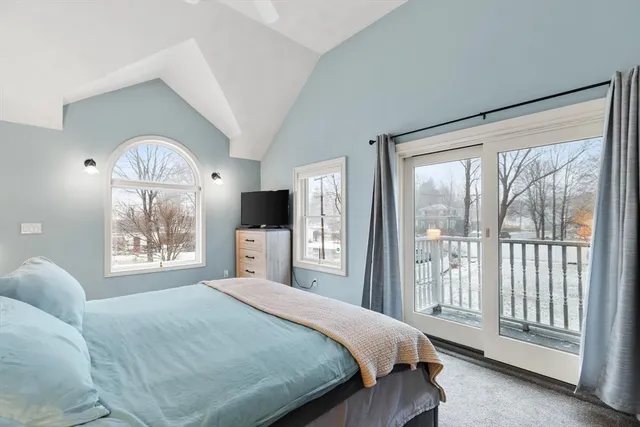 a bedroom with a large bed and a tv