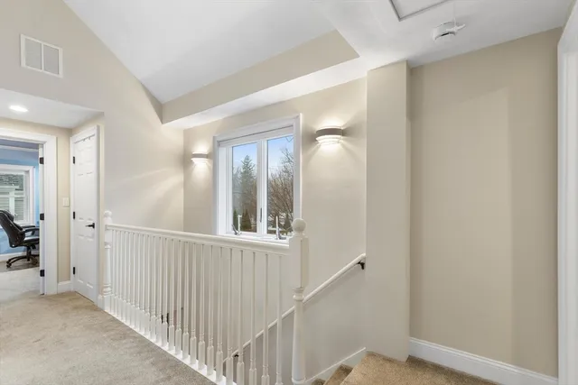 a view of a hallway with wooden floor and entryway