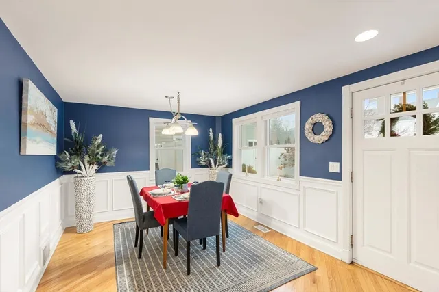 a view of a dining room with furniture and a potted plant