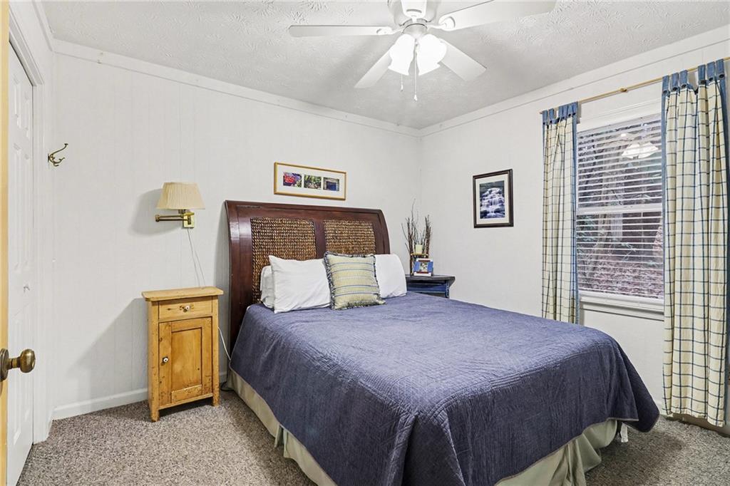 296 Fairview Court Jasper, GA 30143 - Photo 14 of 40 a bedroom with a bed and a chandelier