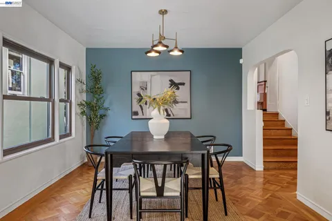 a kitchen with stainless steel appliances white cabinets a stove a sink and a refrigerator