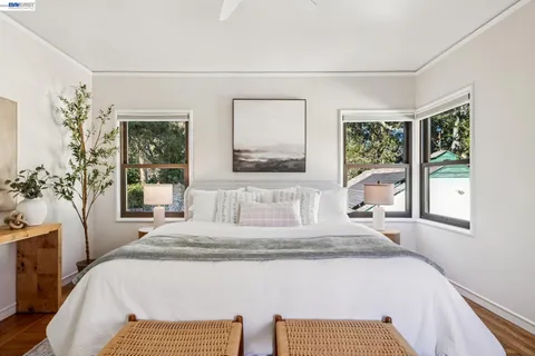 a view of a patio with table and chairs potted plants and a large tree