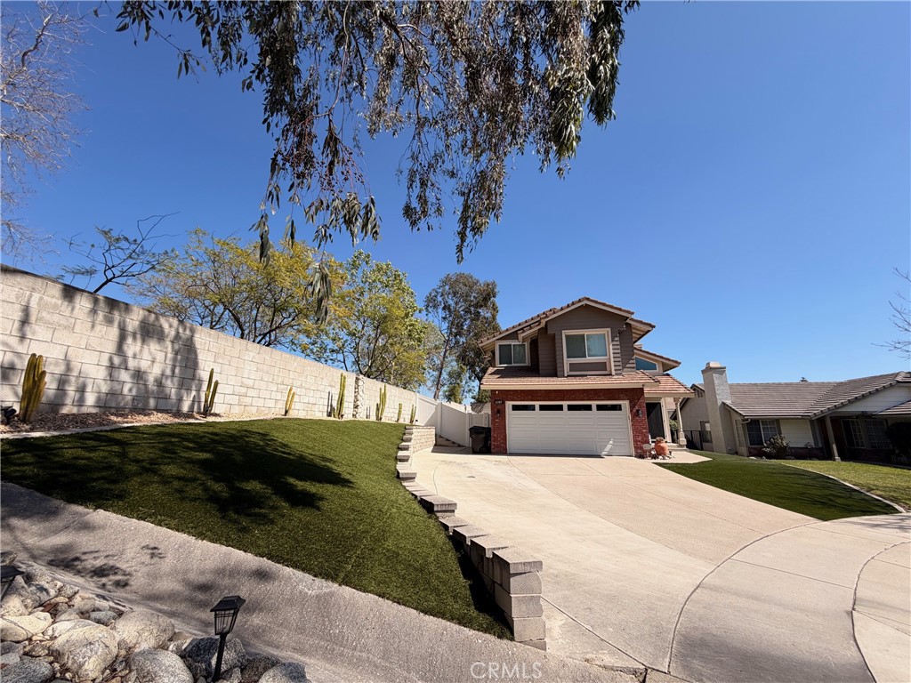 6105 Sherry Court Rancho Cucamonga, CA 91737 - Photo 2 of 35 a front view of a house with a yard