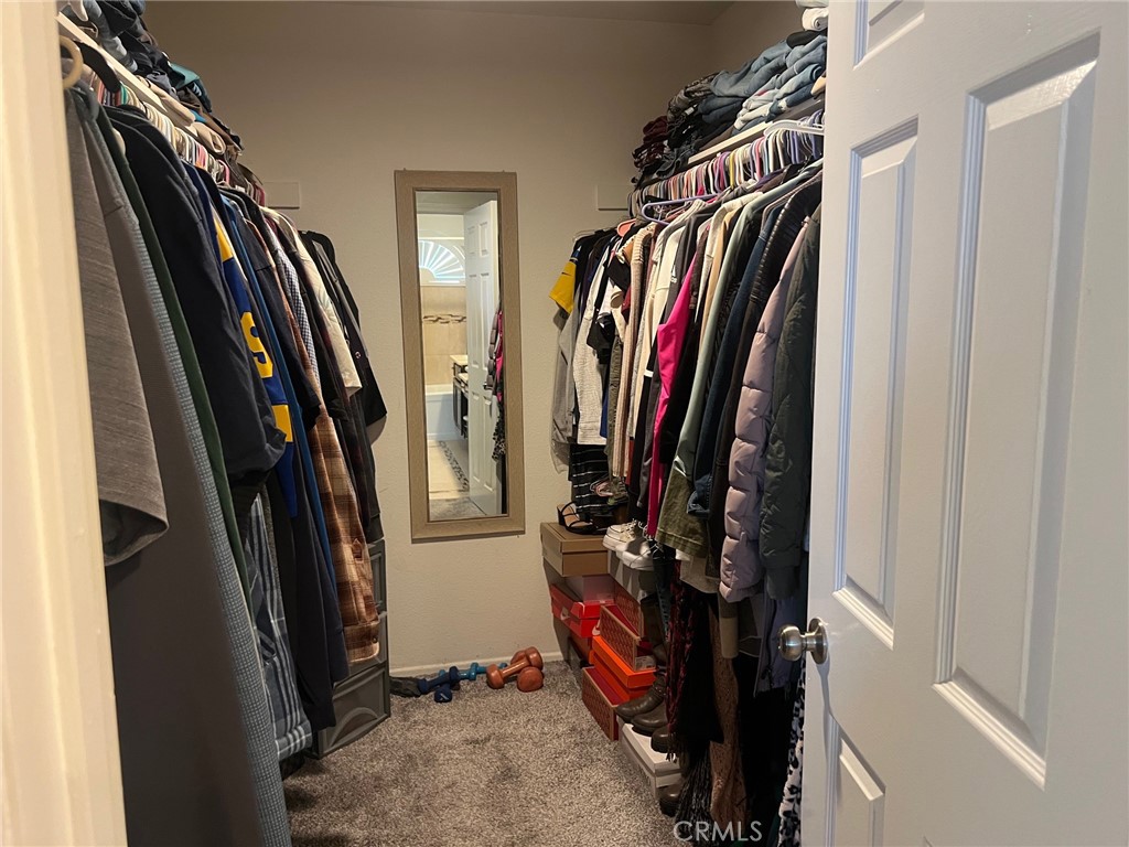 6105 Sherry Court Rancho Cucamonga, CA 91737 - Photo 23 of 35 a view of walk in closet with clothes