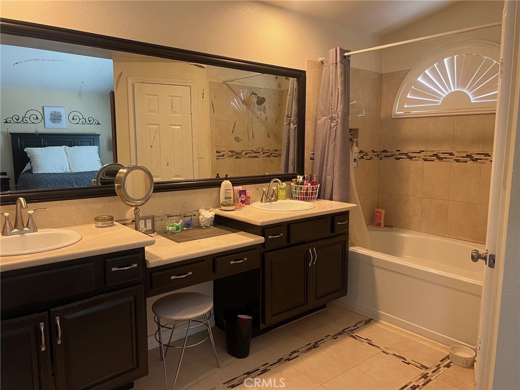 6105 Sherry Court Rancho Cucamonga, CA 91737 - Photo 25 of 35 a bathroom with a double vanity sink a mirror and a bathtub