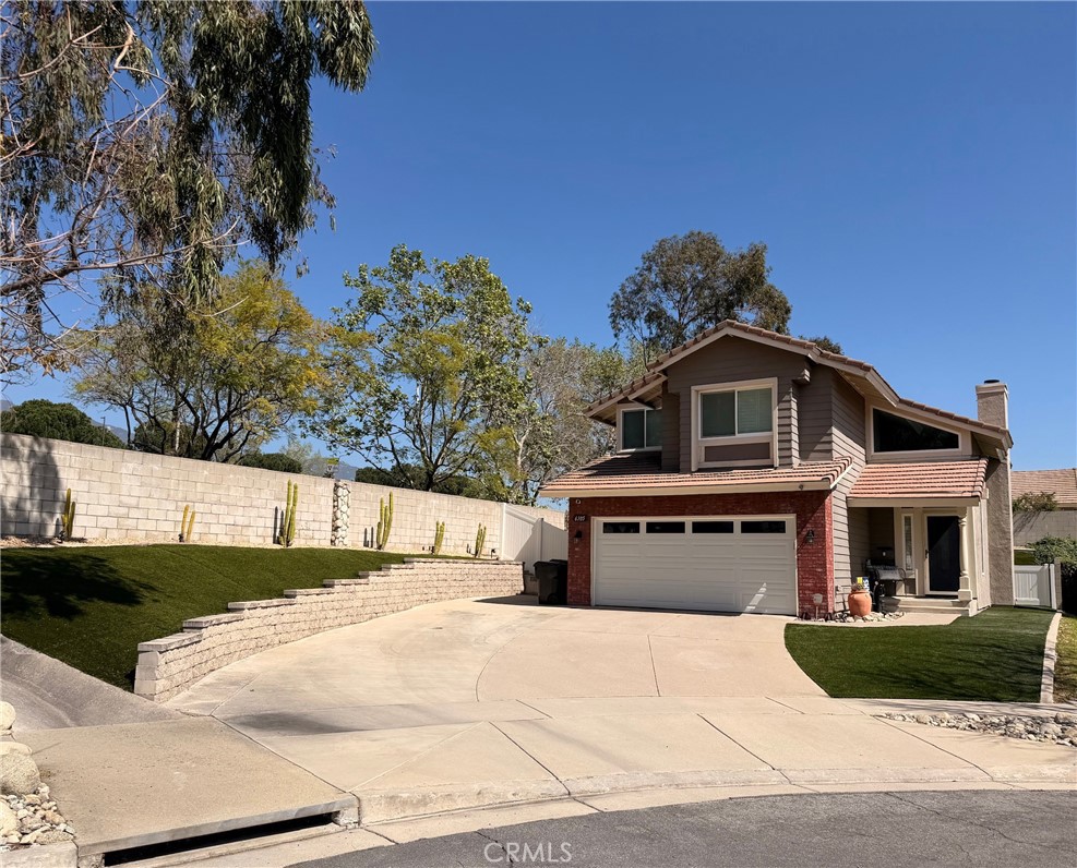6105 Sherry Court Rancho Cucamonga, CA 91737 - Photo 3 of 35 a front view of a house with a garden