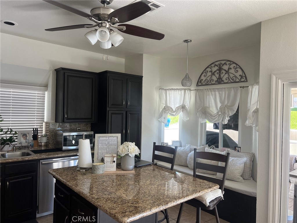 6105 Sherry Court Rancho Cucamonga, CA 91737 - Photo 10 of 35 a kitchen with a table chairs cabinets and window
