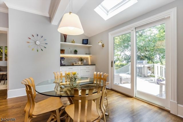 a view of a dining room with furniture and chandelier